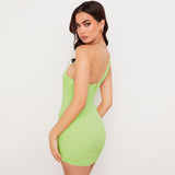 Woman wearing a lime green one-shoulder ruched mesh mini dress, back view