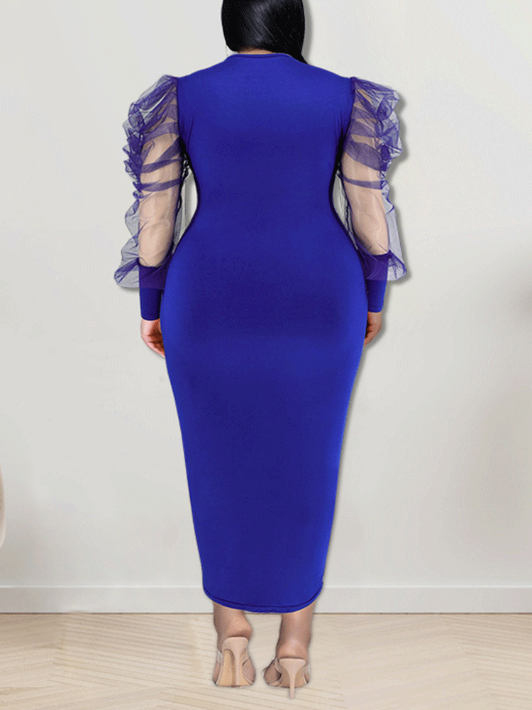 Back view of a woman in a royal blue sheath dress with sheer puff sleeves