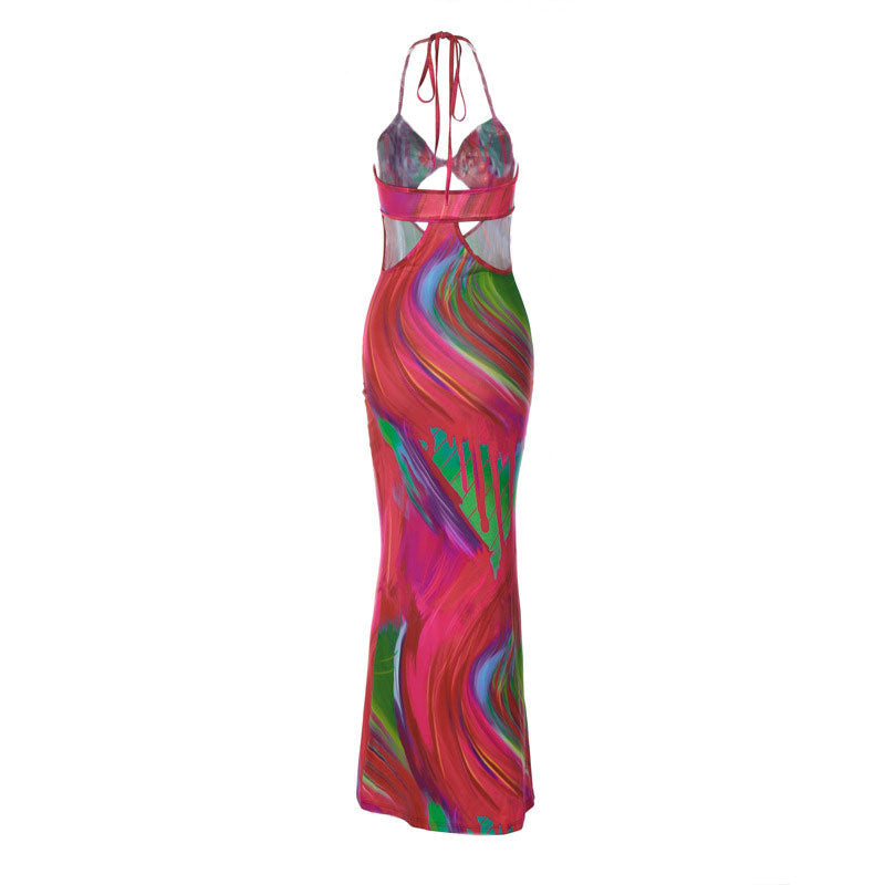 A full-length view of a colorful abstract print maxi dress with cut-out details and a halter neckline.