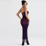 Rear view of a woman in a long, dark purple floral print dress with lace trim and a lace-up back.