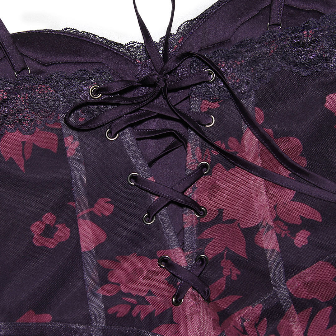 Close-up of the bodice of a dark purple dress, showing lace trim and center front lacing.