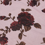 Close-up of the floral print fabric on the dress, showing dark red roses and leaves on a light pink background.