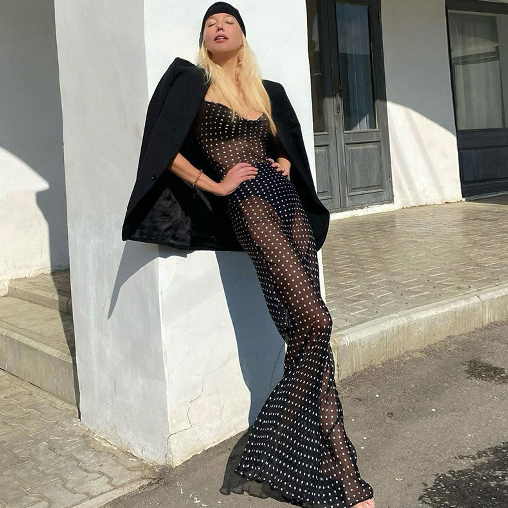 woman in a sheer polka dot maxi dress with a black blazer