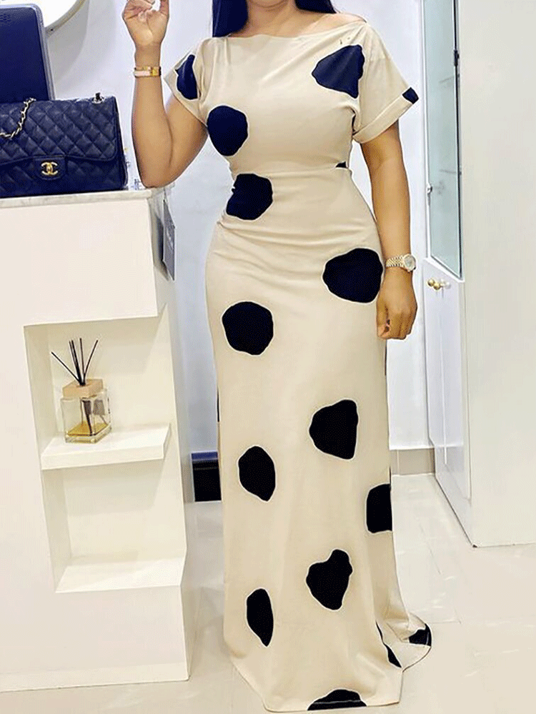 woman posing in a polka dot maxi dress