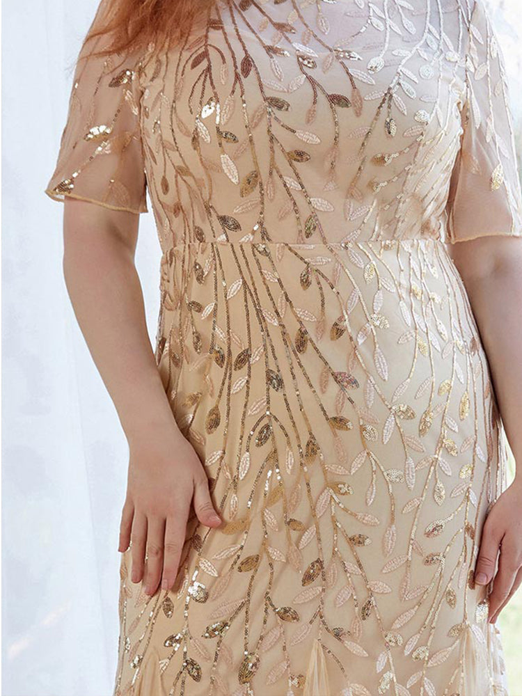 Detail of the sequin embellishment on the bodice of a gold formal dress.