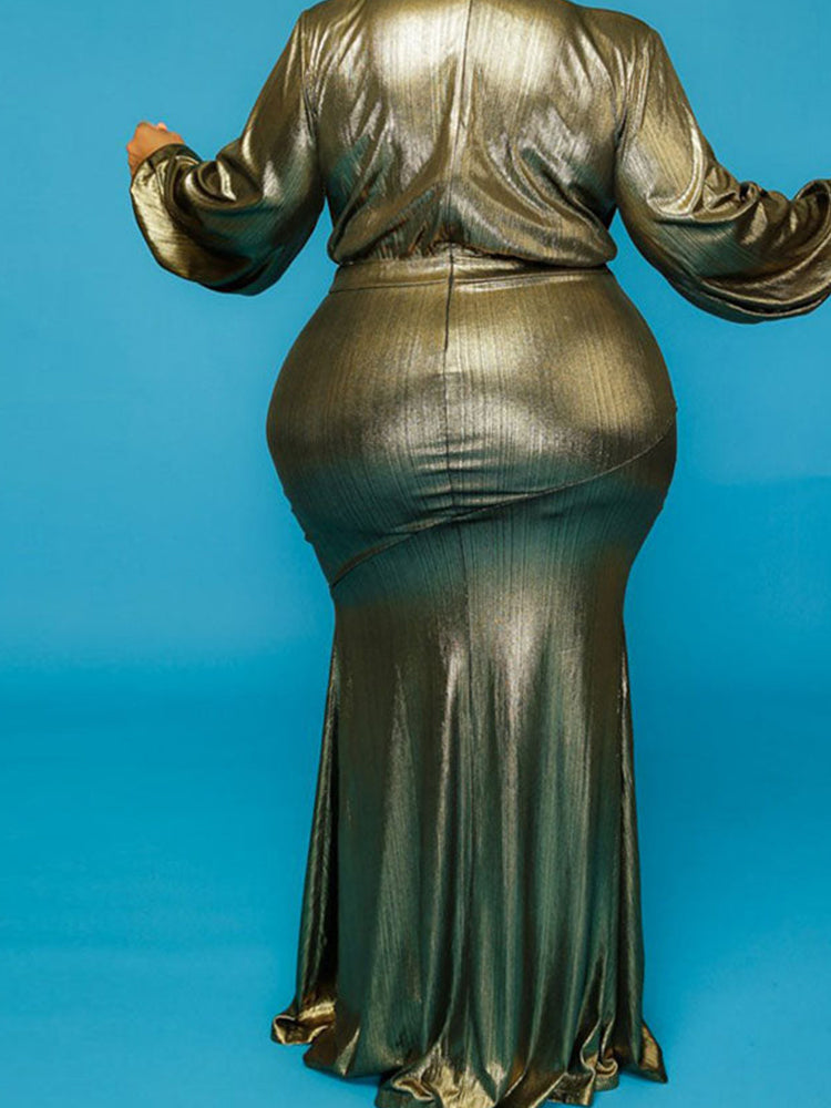 Woman in a gold metallic dress with sleeves outstretched, showcasing the fabric and fit