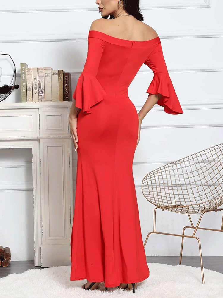 Back view of a woman in a red off-the-shoulder mermaid gown with bell sleeves and a high slit, revealing the zipper closure.