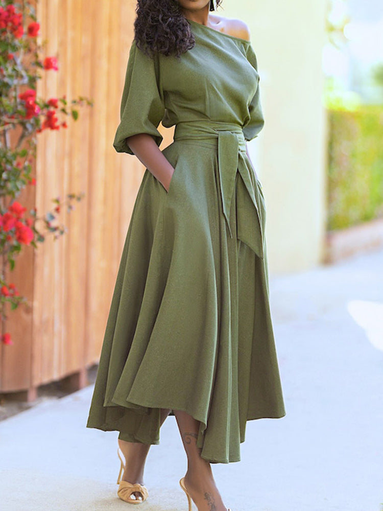 Close-up of a green off-the-shoulder dress with pockets