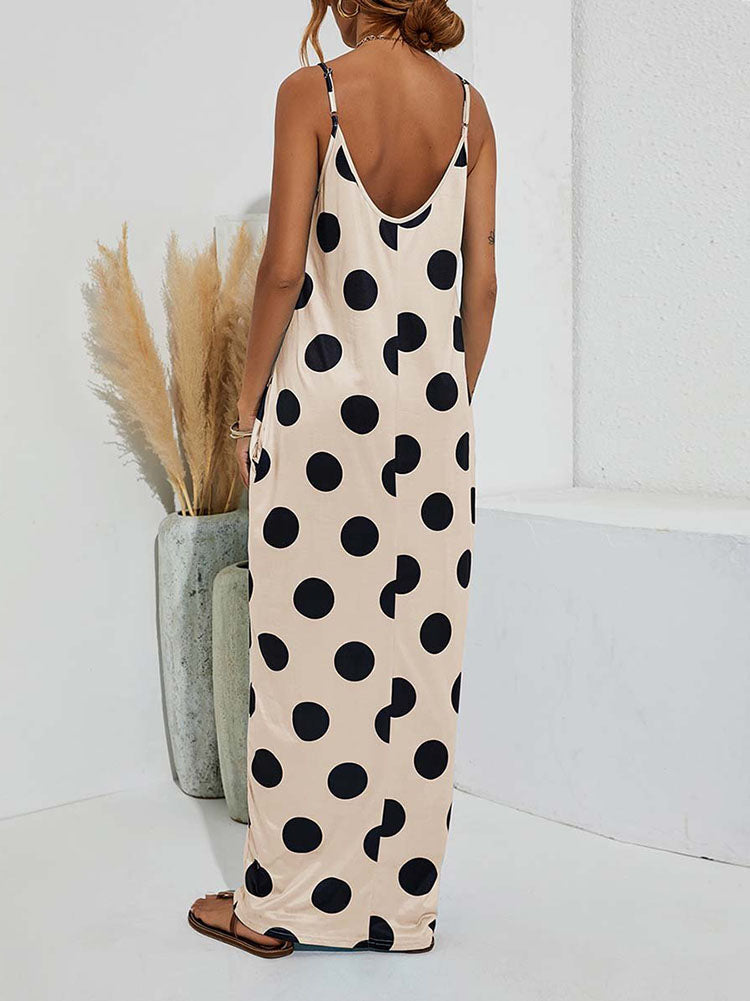 Woman wearing a beige polka dot maxi dress with spaghetti straps and pockets, back view
